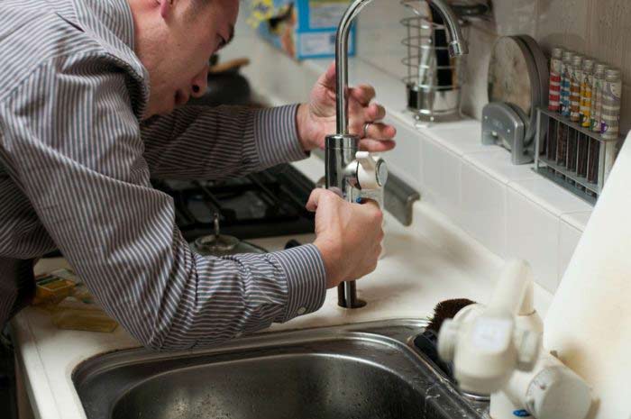 Plumber Working on A Kitchen Faucet in Mesa